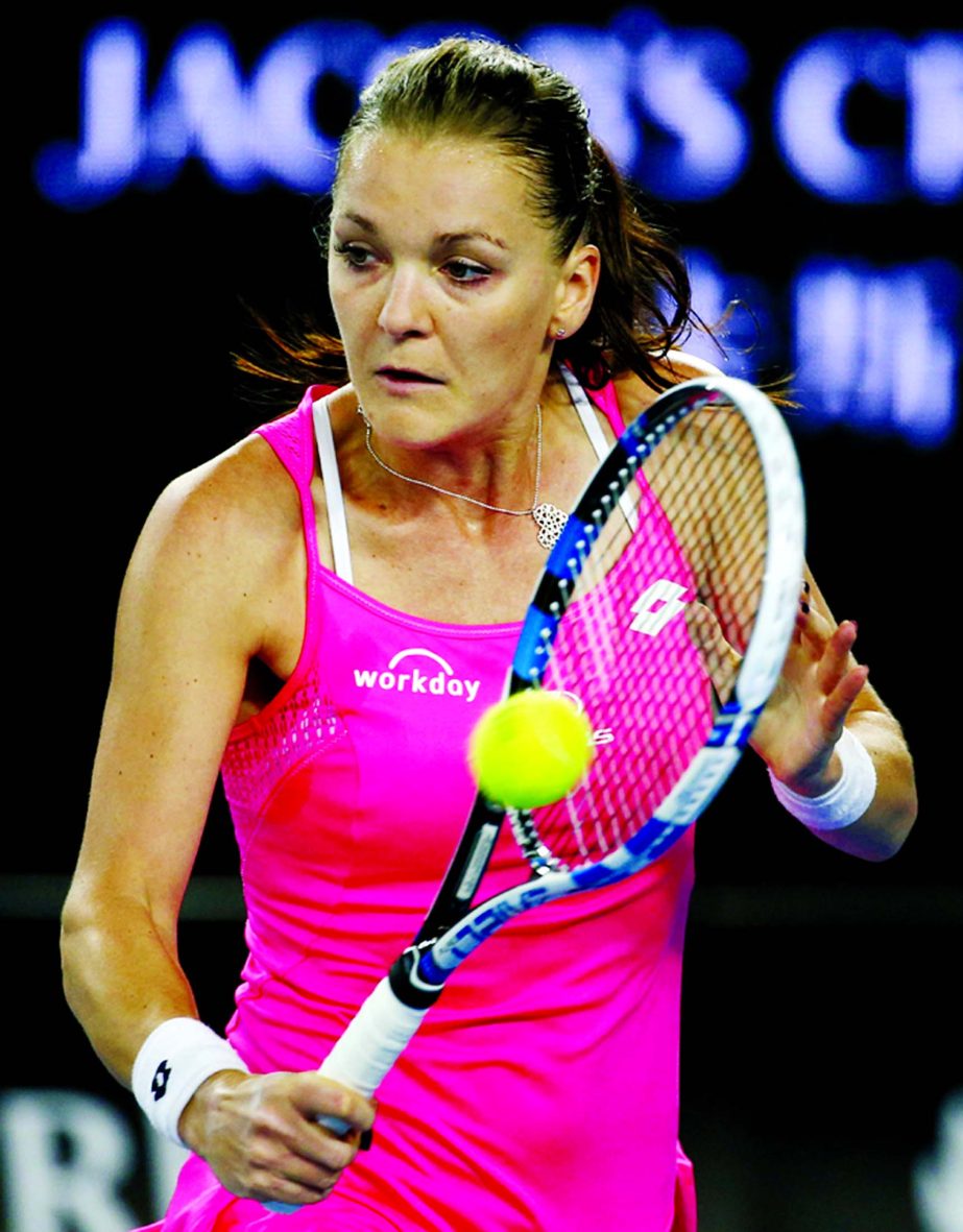 Agnieszka Radwanska of Poland hits a backhand return to Monica Puig of Puerto Rico during their third round match at the Australian Open tennis championships in Melbourne, Australia on Friday,