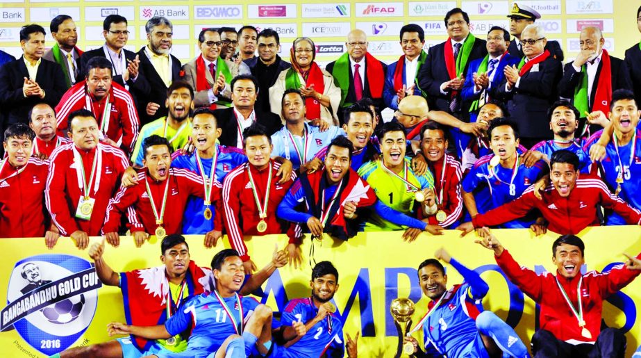 Nepal Football team, the champions of the Bangabandhu Gold Cup International Football Tournament with Chief Guest Prime Minister Sheikh Hasina pose with the trophy at the Bangabandhu National Stadium on Friday.