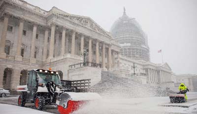 Snow is cleared outside the US Capitol in Washington on Friday.