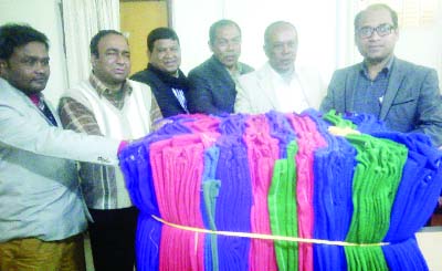 SAGHATA(Gaibandha) : UNO Safiuzzaman distributing winter clothes among the cold-hit people on behalf of Rice Mill Ownersâ€™ Association on Thursday.