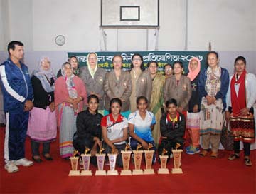 The winners of the Inter-District Women's Badminton Competition and the officials of Bangladesh Women's Sports Association pose for a photo session at the Sultana Kamal Women's Sports Complex in Dhanmondi on Saturday.