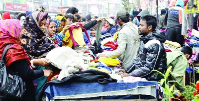 RAJSHAHI: People rush at different roadside shops for buying winter clothes in Rajshahi yesterday.