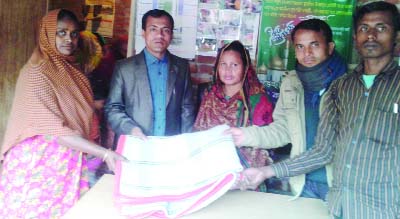 JOYPURHAT: Md Kamruzaman Babu, President, Bhuidoba Palli Unnayan Mahila Sangstha distributing winter clothes among the poor people at Panchbibi Upazila yesterday.