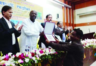 JHENAIDAH : Farmer Altaf Hossain of Jhenaidah receiving award from the Makbul Hossain MP ,Chairman , Parliamentary Standing Committee on the Ministry of Agriculture at Khamarbari in Dhaka recently.