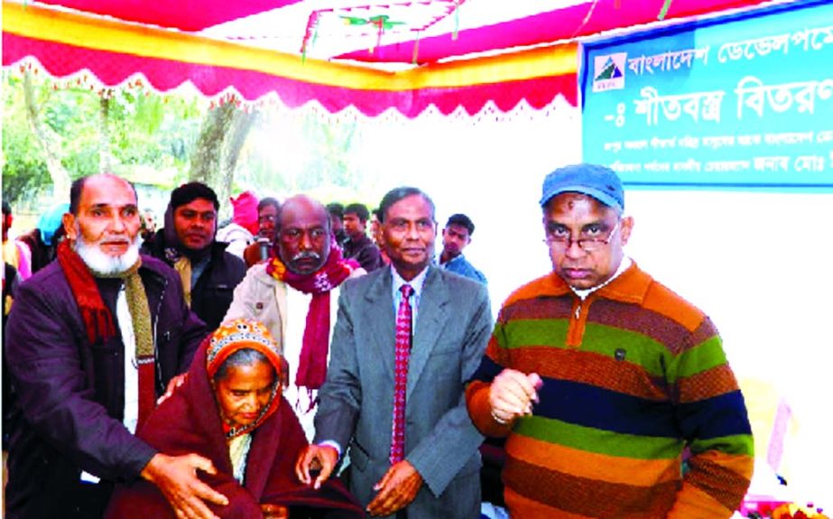 Md Yeasin Ali, Chairman, Board of Directors of Bangladesh Development Bank Limited distributing blanket among the poor at Kaonia area in Rangpur on Sunday. Rangpur Branch Manager AKM Azad Faruque and local UP Chairman were among others were present.