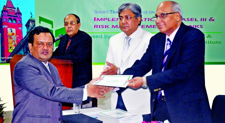 Syed Mohammad Bariqullah, Deputy Managing Director of National Bank Limited handing over certificates among the participants of a training course on "Implementation of Basel-III and Risk Management in Banks" at the Training Institute of the bank in the