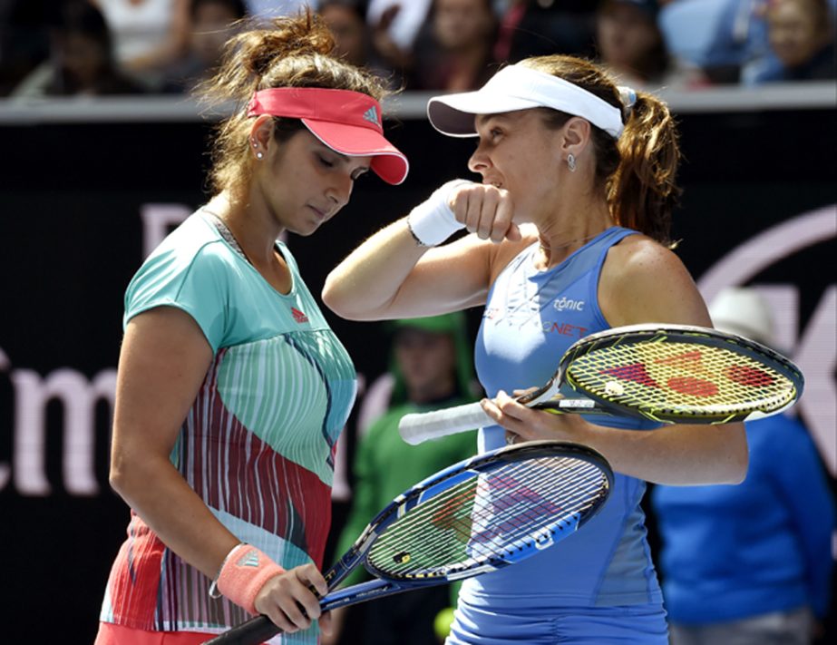 Martina Hingis (right) of Switzerland and Sania Mirza of India talk during their third round match against Roberta Vinci of Italy and Svetlana Kuznetsova of Russia at the Australian Open tennis championships in Melbourne, Australia on Monday.