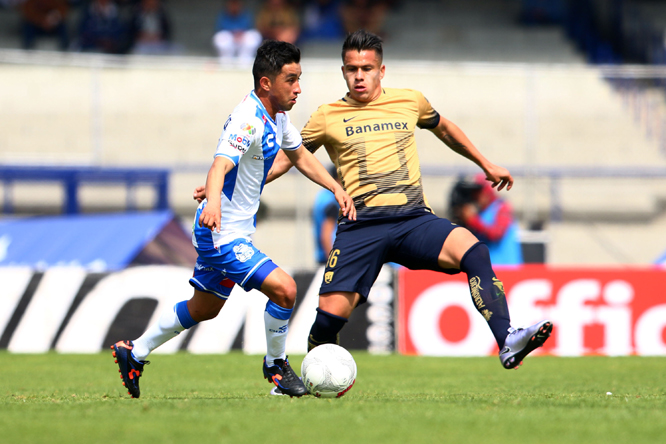 Pumas' Marcelo Alatorre, (right) fights for the ball with Puebla's Matias Ulustiza during a Mexican soccer league match in Mexico City on Sunday.
