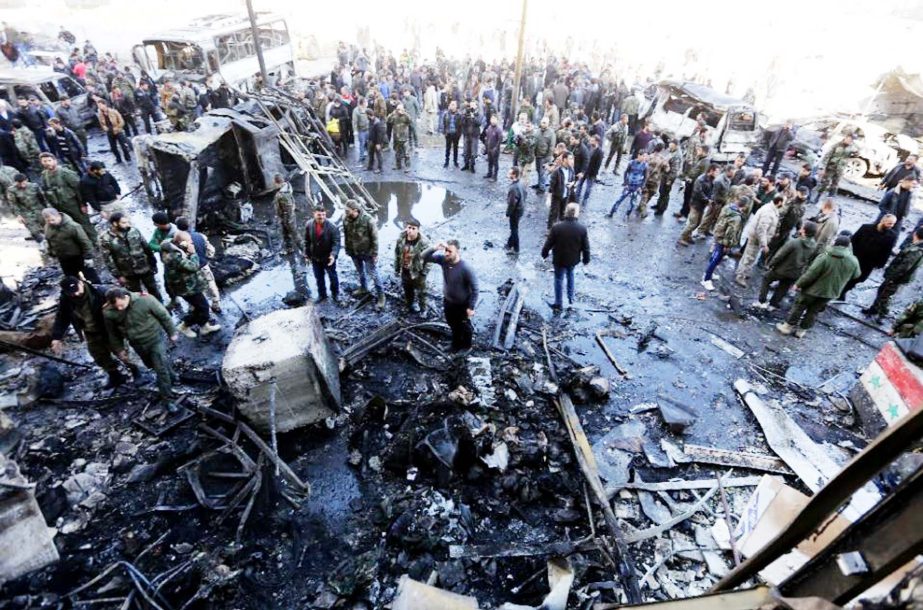 Residents and soldiers loyal to Syria's President Bashar al-Assad inspect damage after a suicide attack in Sayeda Zeinab, a district of southern Damascus, Syria on Sunday.