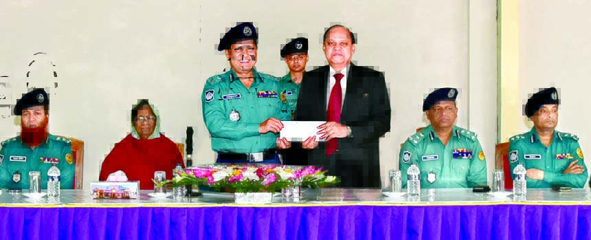 Md Asaduzzaman Mia, DMP Commissioner, receiving a pay order of Tk. 6.5m for construction cost of a Modern Multipurpose Shed at Rajarbag Police Lines from KS Tabrez, Managing Director of Dutch-Bangla Bank at a ceremony at Rajarbag Police Lines, Dhaka on Mo