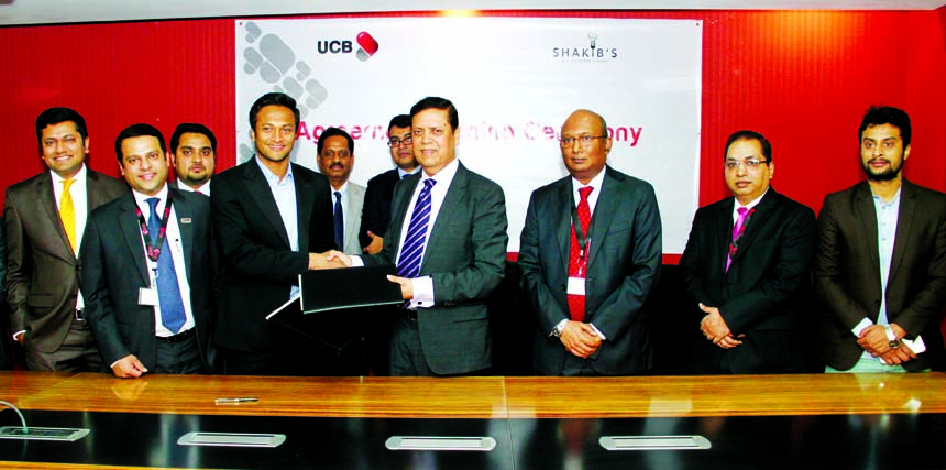 Muhammed Ali, Managing Director of United Commercial Bank Limited and Shakib Al Hasan, owner of SHAKIB's, a restaurant located at Banani, Dhaka, sign an agreement in the city on Tuesday. Under this agreement, UCB Imperial Customers and UCB Platinum Credi