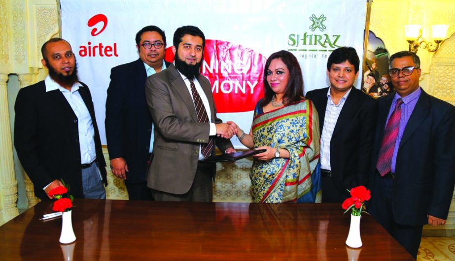 Azmat Ullah Khan, Head Corporate and Platinum Service of Airtel Bangladesh exchanging agreement documents with Seema Haider Chaudhury, Proprietor of Shiraz Restaurant at Shiraz Restaurant in the city recently.