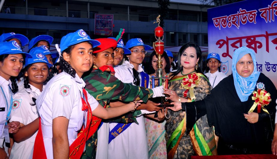 Nobina Mizan, wife of Log Area Commander of Headquarters of Bangladesh Army handing over the trophy to Begum Rokeya House, the champions of the Inter-House Annual Sports Competition of Shaheed Bir Uttam Lieutenant Anwar Girls' College at Dhaka Cantonment