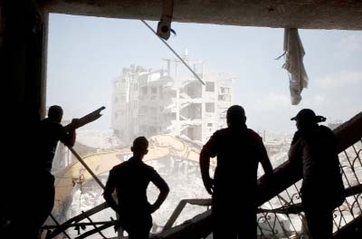 Palestinian men look at the destruction in part of Gaza City's al-Tufah neighbourhood.