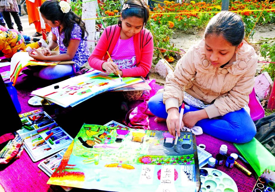 Children engrossed in painting at a drawing competition organized on the occasion of Ekushey Book Fair at Public Library in the city on Friday.