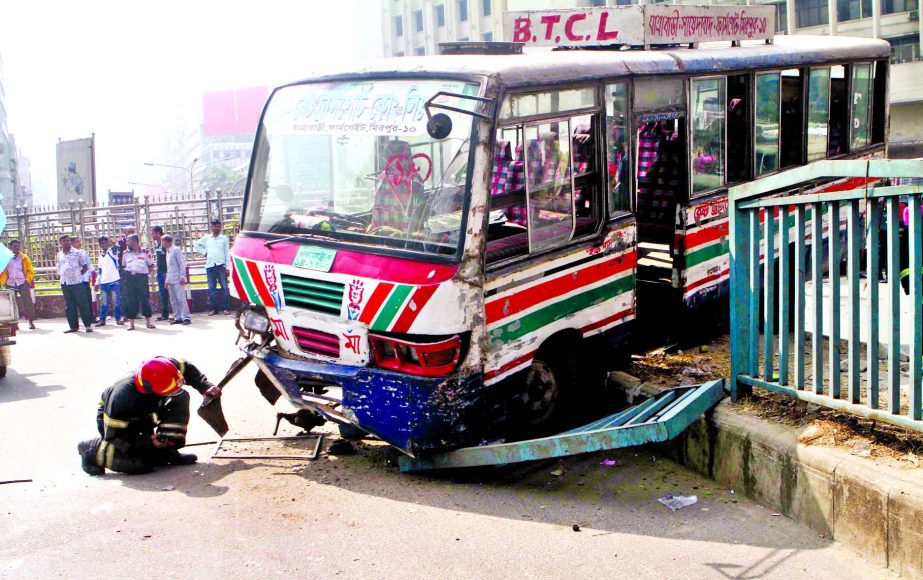 A passenger bus rams into island near Shapla Chattar at Motijheel area in city due to driver's reckless driving on Friday.