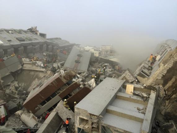 Rescue personnel work on damaged buildings after an earthquake in Tainan, southern Taiwan, February 6, 2016. ReutersPichi Chuang