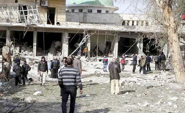 People inspect the damage after airstrikes by pro-Syrian government forces in the rebel held al-Sakhour neighbourhood of Aleppo, Syria on Friday.