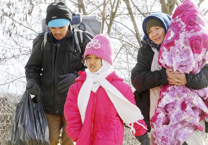 A family of refugees walks towards the border with Serbia from the transit center for refugees near northern Macedonian village of Tabanovce on Friday. AP file photo