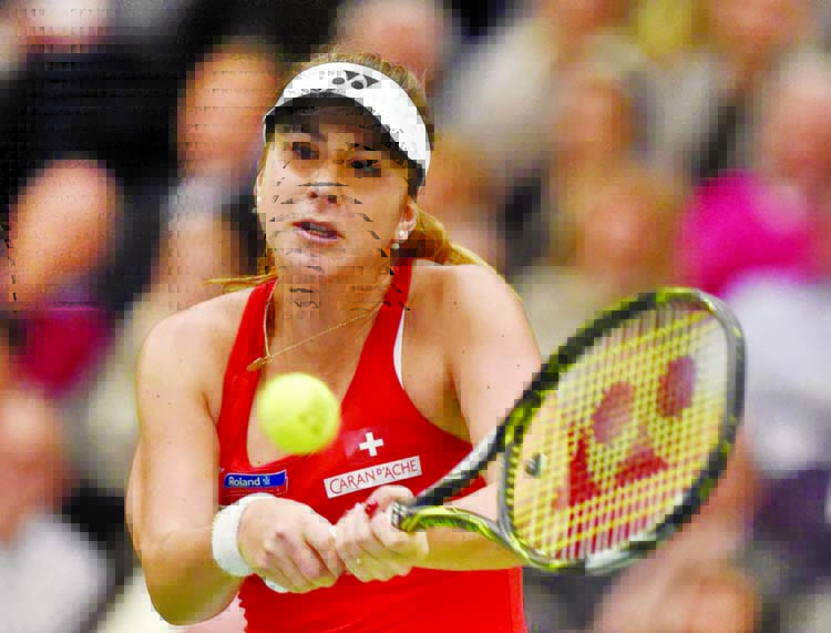 Belinda Bencic of Switzerland returns a ball to Andrea Petkovic of Germany during the Fed Cup World Group first round tennis match between Germany and Switzerland in Leipzig, Germany on Saturday.