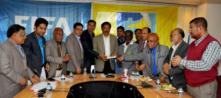 Minister for Chittagong Hill Tracts Affairs Bir Bahadur Ushwi Sing, MP handing over the cheque of Tk 5,00,000 to Munir Hossain, the Vice-President of Bangladesh Football Referees Association at the conference room of Bangladesh Football Federation House o