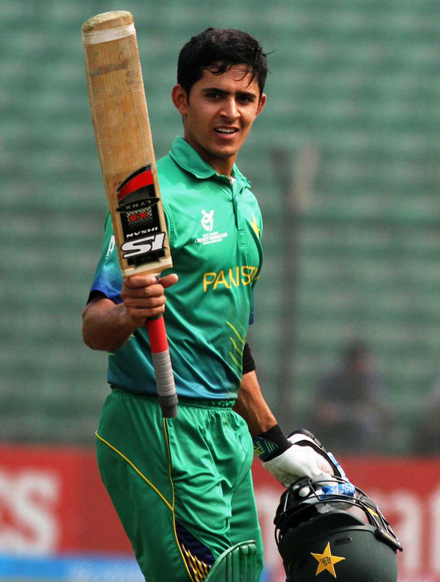 Umair Masood raises his bat after scoring his century