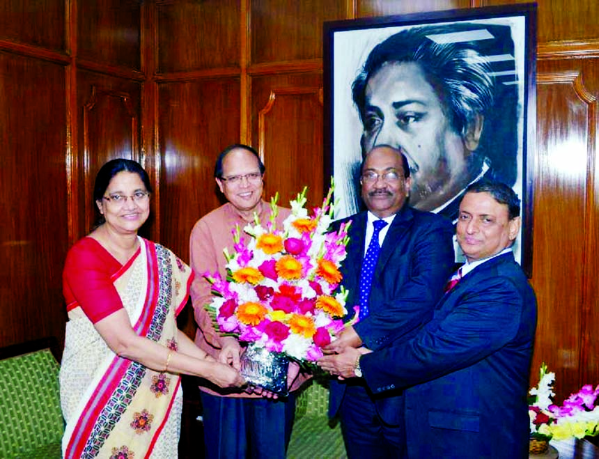 Bangladesh Bank Governor Dr. Atiur Rahman greetings the newly appointed three deputy governors Abu Hena M Razee Hasan, SK Sur Chowdhury and Nazneen Sultana at the conference room of the central bank in the city on Monday.