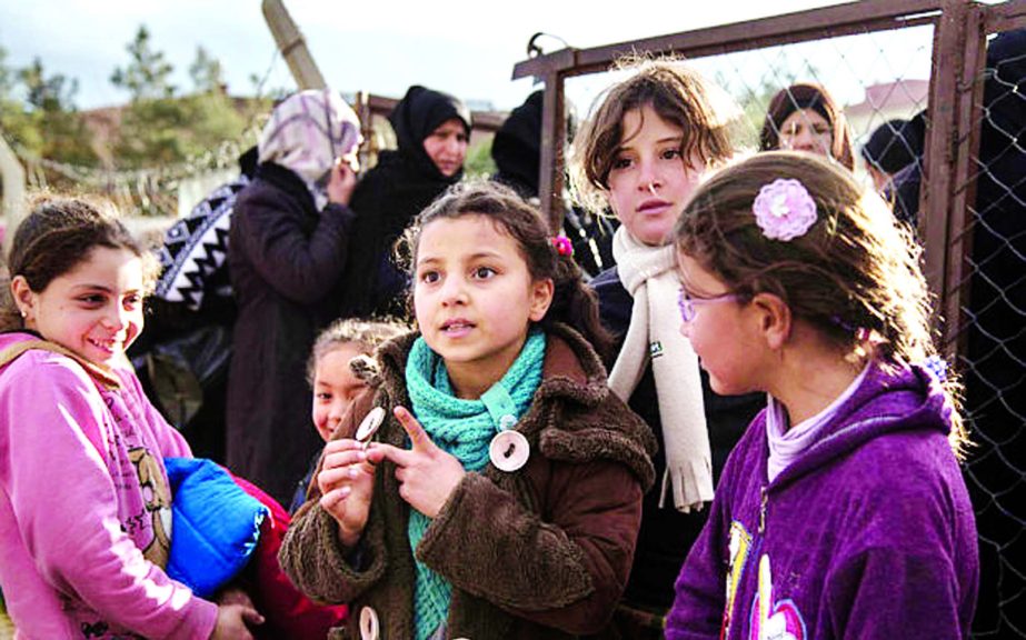 Refugees from Syria queue up to receive food at charity kitchen in Kilis, Turkey, near the Syrian border