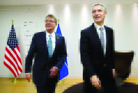US Secretary of Defense Ash Carter (L) walks with NATO Secretary General Jens Stoltenberg at NATO headquarters in Brussels on Wednesday.