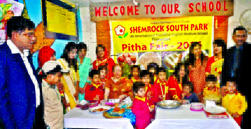 Teachers and students of Shemrock South Park, an International English Medium School in the city's Tikatuli pose for photograph at the annual cake festival of the school at its premises on Thursday.