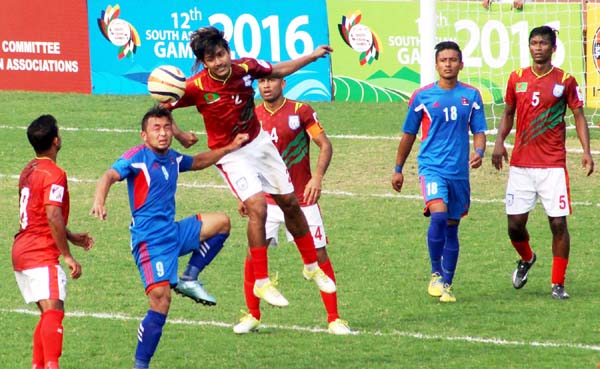 An action from the football match of the South Asian Games between Bangladesh Football team and Nepal Football team match at Nehru Stadium in Ulubari on Thursday.