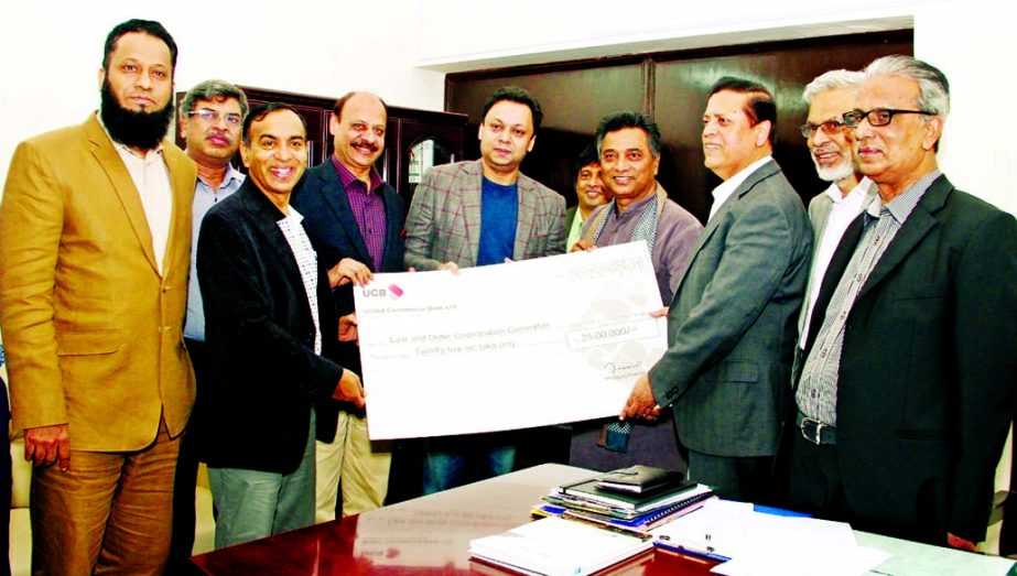 Showkat Aziz Russell, Director, United Commercial Bank Limited handing over the donation cheque for CCTV Surveillance project Law and Order Coordination Committee of Dhaka Metropolitan Police to Annisul Huq, Mayor, Dhaka north City Corporation. Muhammed A