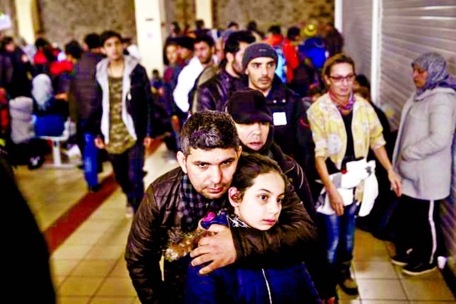 Refugees and migrants line up to receive a meal inside a terminal, moments after arriving aboard the Tera Jet passenger ship at the Port of Piraeus, near Athens, Greece.
