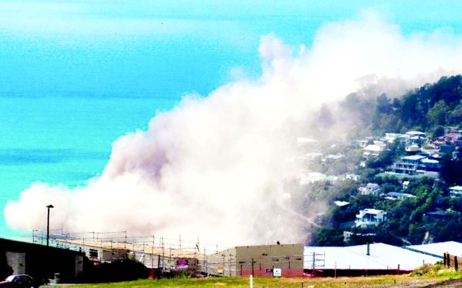 Dust and debris rise above houses after a cliff collapsed due to an earthquake on the Whitewash Head area, located above Scarborough Beach in the suburb of Sumner, Christchurch, New Zealand on Sunday.