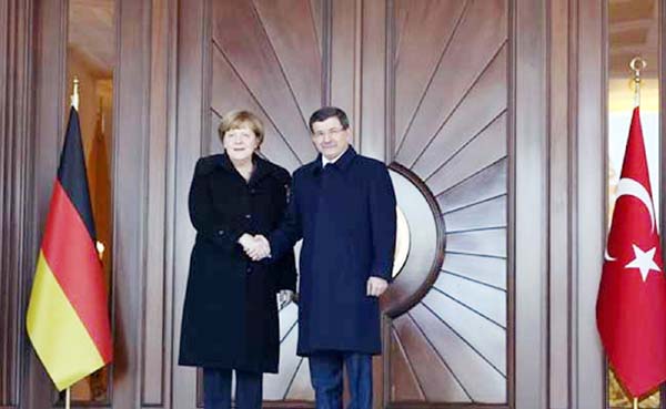 German Chancellor Angela Merkel, left, and Turkish Prime Minister Ahmet Davutoglu shake hands during a welcoming ceremony in Ankara.