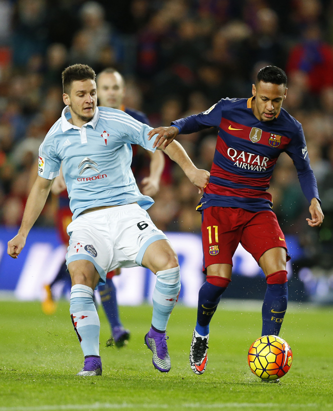 FC Barcelona's Neymar, right, duels for the ball against Celta Vigo's Nemanja Radoja during a Spanish La Liga soccer match at the Camp Nou stadium in Barcelona, Spain, Sunday,