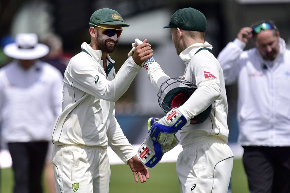 Australia's Peter Nevill (centre R) with teammate Nathan Lyon celebrate their win on day four of the first cricket Test match between New Zealand and Australia at the Basin Reserve in Wellington on Monday.