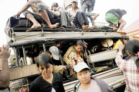 Residents fleeing conflict areas near the Myanmar and Chinese border arrive in a temporary refugee camp at a monastery in Lashio, northern Myanmar.