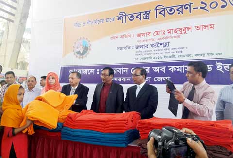 President Chittagong Chamber of Commerce & Industries Mahbubul Alam distributing winter clothes among the cold-hit people at Holiday Resort in Bandarban recently.