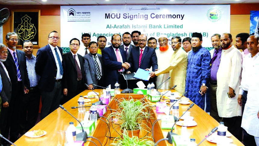 Md. Habibur Rahman, Managing Director of Al-Arafah Islami Bank Ltd exchanging documents with Mohammad Ibrahim Bahar, President of HAAB at the board room of the bank in the city on Wednesday.