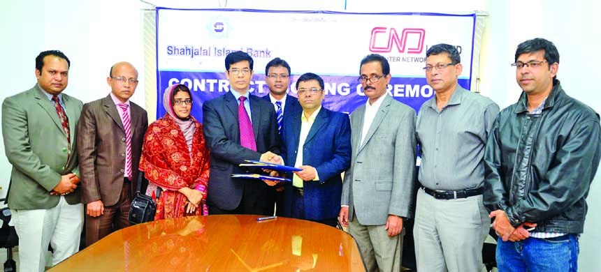 Deputy Managing Director of Shahjalal Islami Bank Limited M Akhter Hossain exchanging documents with Director of Computer Network Systems Limited (CNS) Ikram Iqbal in the city recently.