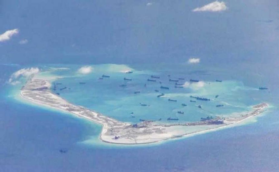 China confirmed that it has weapons on a disputed island in the South China Sea, state media said.