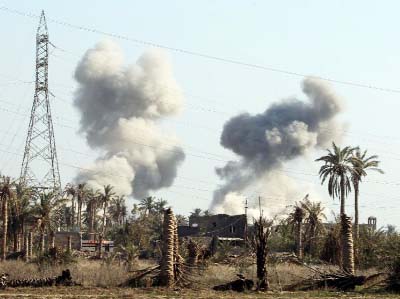 Smoke billows following a reported air strike by the US-led coalition in the area of al-Sajariyah area, east of the city of Ramadi, Iraq.