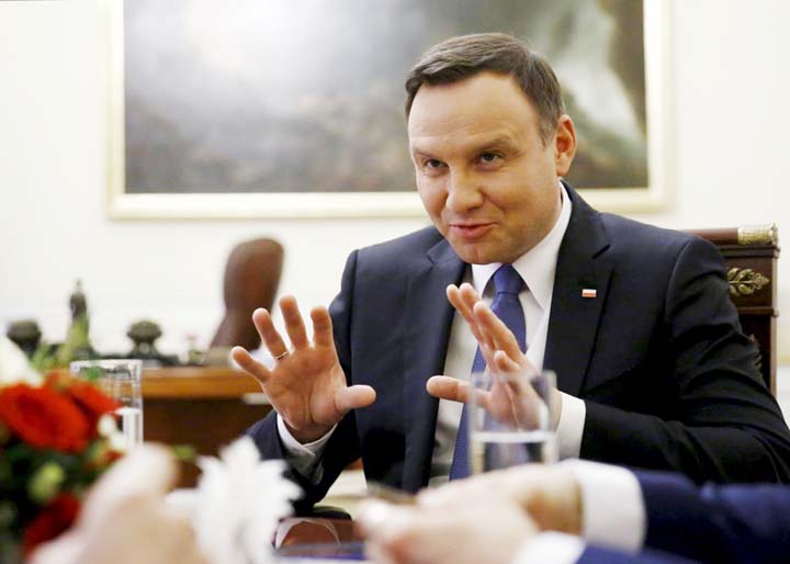 Poland's President Andrzej Duda gestures as he speaks during interview at the Presidential Palace in Warsaw, Poland.