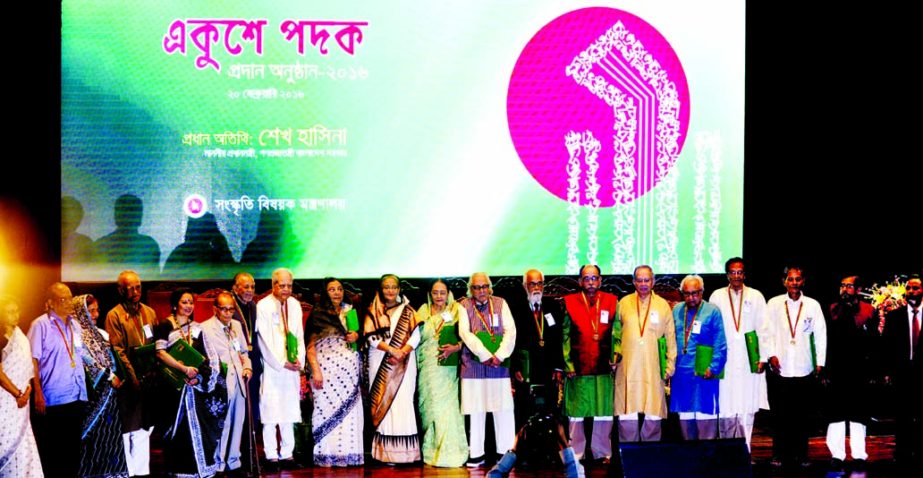 Prime Minister Sheikh Hasina poses for photograph with 'Ekushey Padak' recipients at Osmani Memorial Auditorium in the city on Saturday. BSS photo