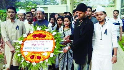 SYLHET: Students and teachers of Gausul Azam Abul Ulaiya Madrasa placing wreaths at Shaheed Minar in the madrasa compound marking the Interionational Mother Language Day on Sunday.