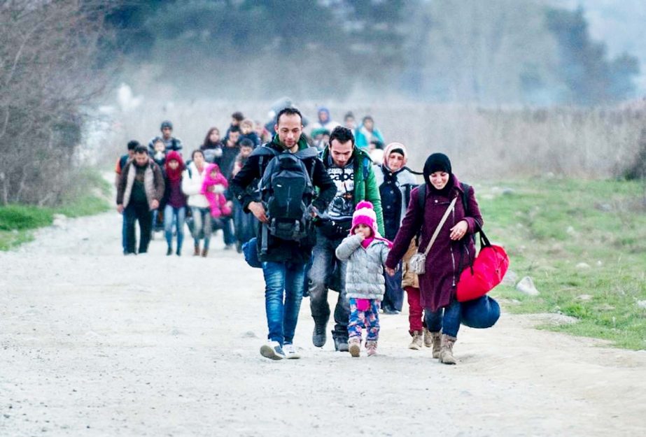 Migrants and refugees from Syria and Iraq cross the Greek-Macedonian border near the town of Gevgelija on Tuesday.