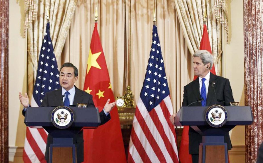 US Secretary of State John Kerry, right, listens as Chinese Foreign Minister Wang Yi, left, speaks during a media availability at the State Department in Washington on Tuesday.