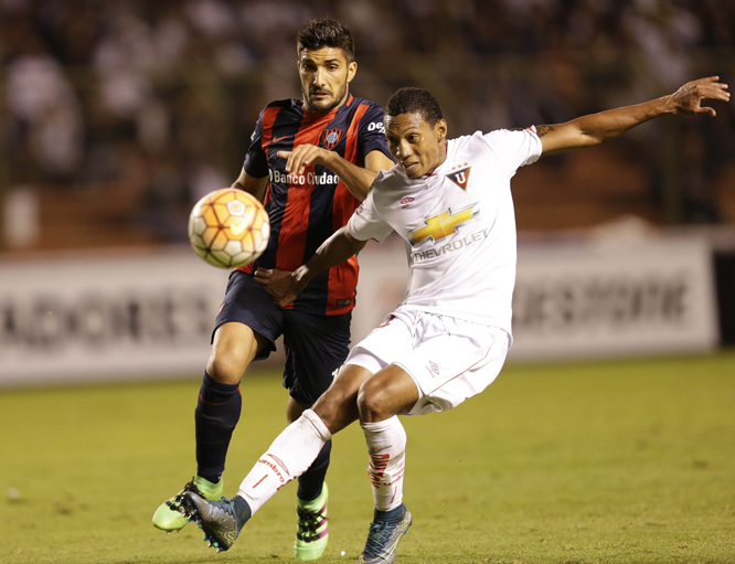 Jose Quintero of Ecuador's Liga Deportiva Universitaria, right, fights for the ball with Nicolas Blandi of Argentina's San Lorenzo during a Copa Libertadores soccer match in Quito, Ecuador on Tuesday.