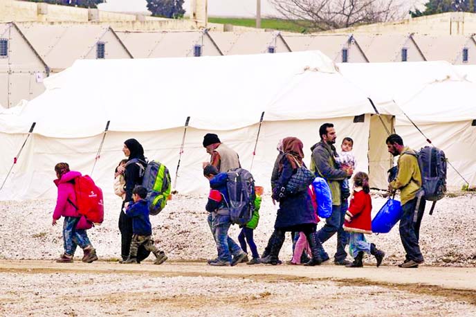 400 refugees and migrants make their way at a relocation camp in the village of Diavata, near the northern port city of Thessaloniki, Greece.